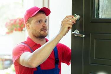 Photo of a Gloucester locksmith checking that a newly installed door lock is working. 